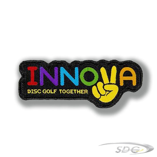 Innova Iron On Patch with Innova In Rainbow Color Text a hand with peace sing making the letter V-disc Golf together in yellow text underneath surrounded by a black outline 