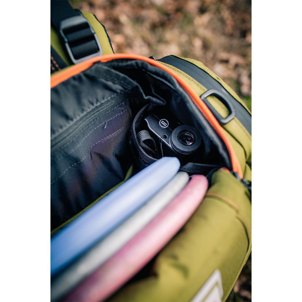 Squatch Legend 3.0 Disc Golf Backpack w/ Cooler Disc Golf Bag Forest-Orange inside view of top pocket with Bushnell rangefinder and putters