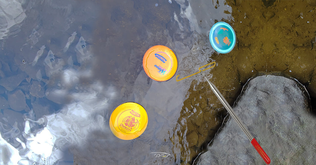 Disc Golf Bag near pond with Disc Golf Discs Floating in water 