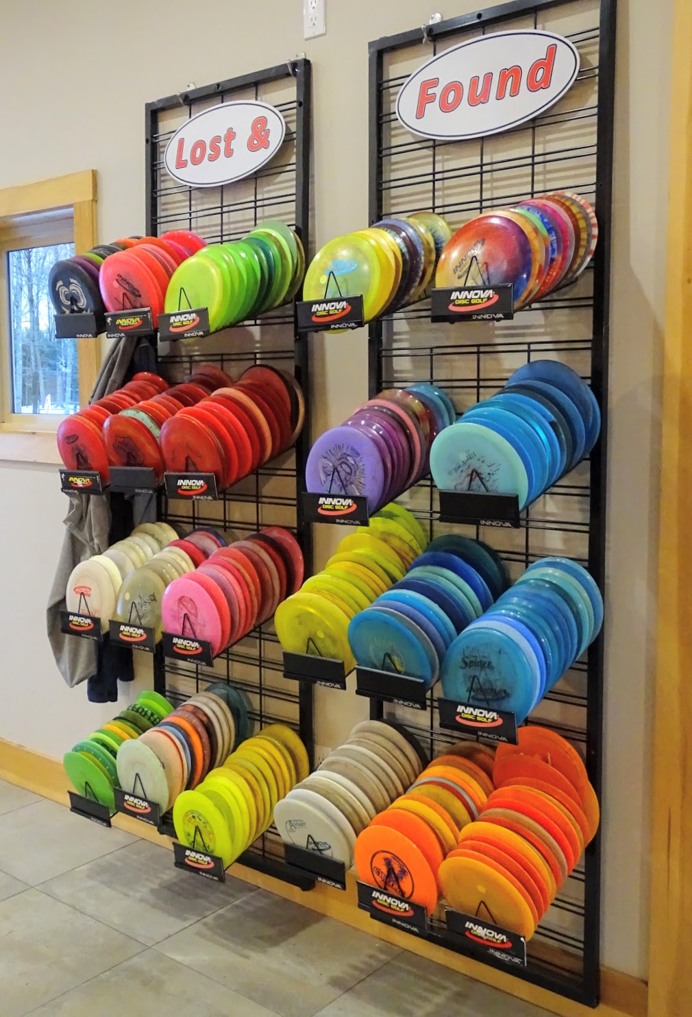 wall of lost and found discs at sabattus disc golf
