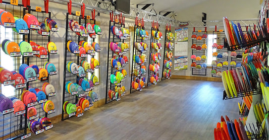 inside of the Sabattus disc golf Pro Shop with racks of discs