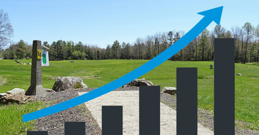 Teepad 14 of Sabattus Disc Golf's Eagle course behind a blank upward moving graph.