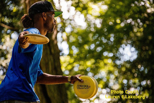 Innova sponsored disc golfer philo brathwaite getting ready to put with a yellow aviar. 