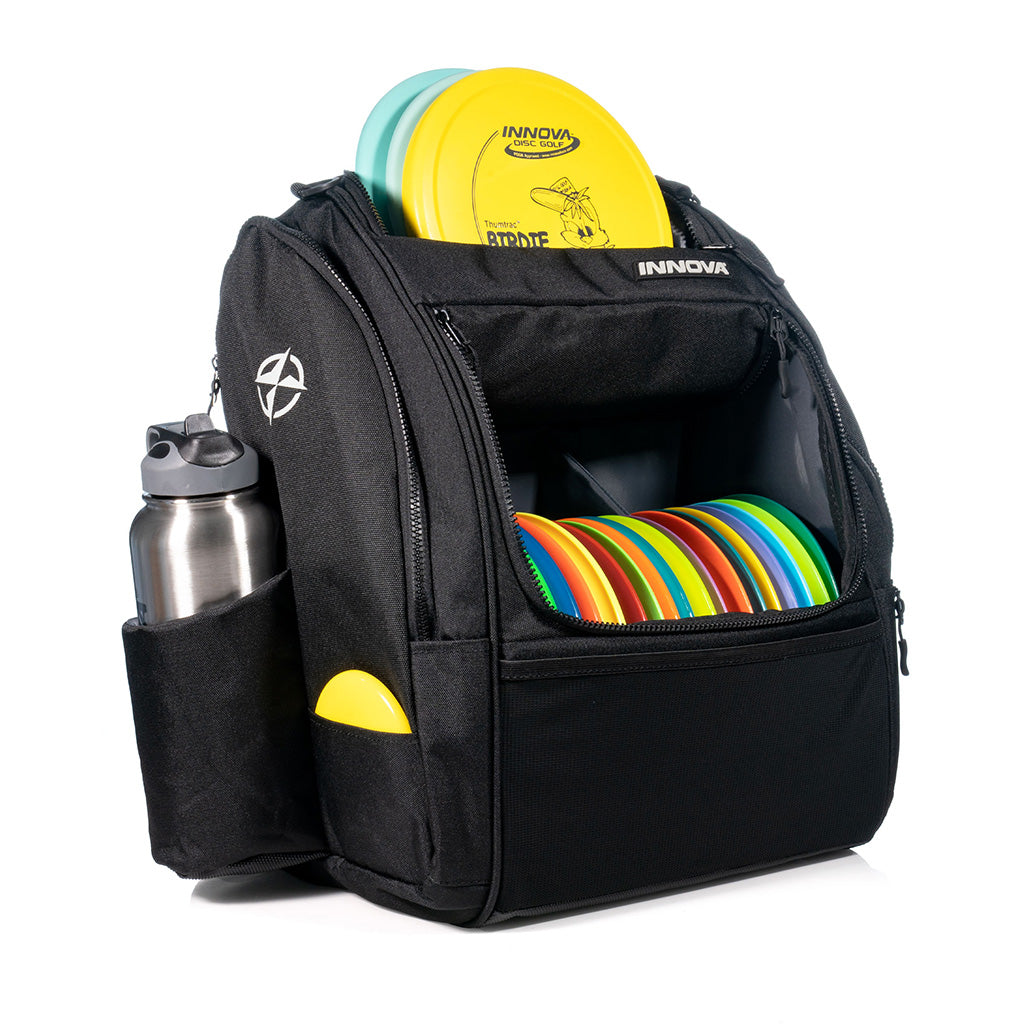Innova Safari Pack Backpack Disc Golf Bags Black filled with an assortment of discs, mini marker & canteen